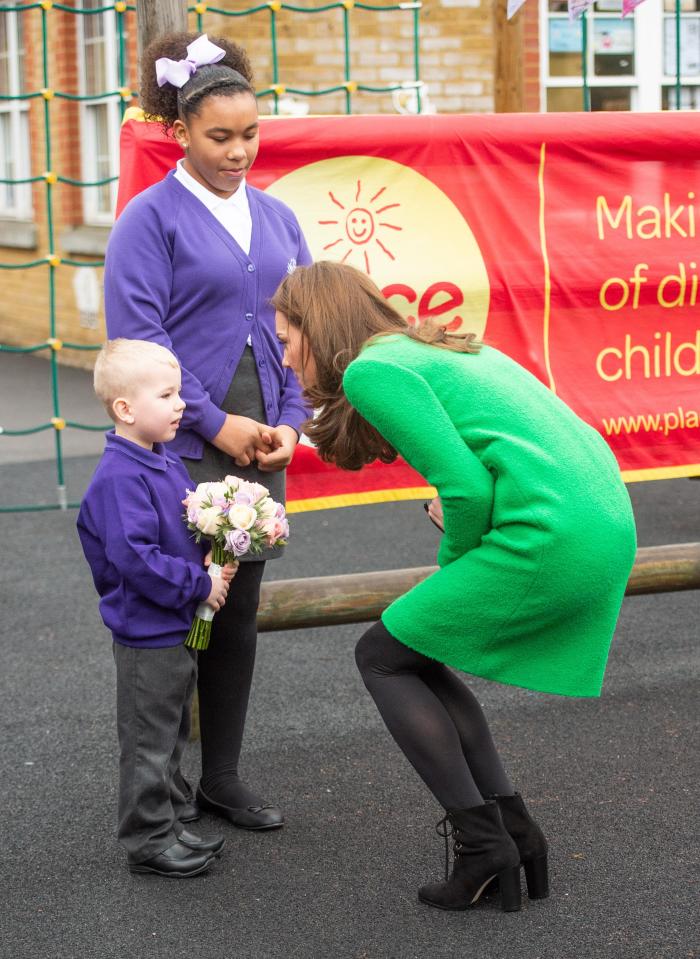  She crouched down to say hello to an adorable pupil and accept a posey