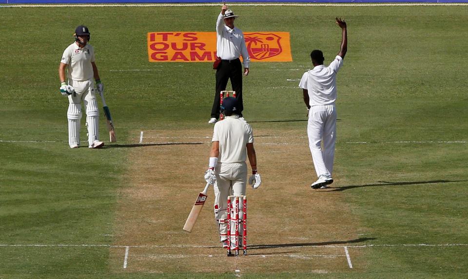  Alzarri Joseph celebrates taking the wicket of Joe Root