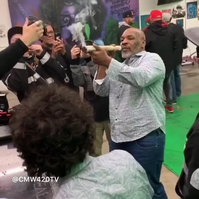 Mike Tyson can be seen smoking a huge joint at a marijuana event