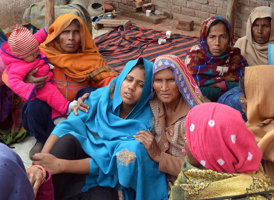  A woman is consoled after her husband's death from bootleg alcohol in Saharanpur. Doctors had concluded many victims died 'due to liver infection and problems in their respiratory system'