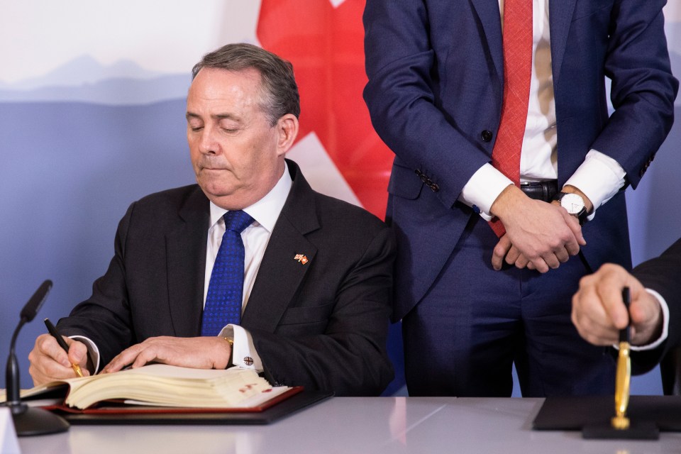 TRADE boss Liam Fox signs a trade deal with the Swiss in Bern