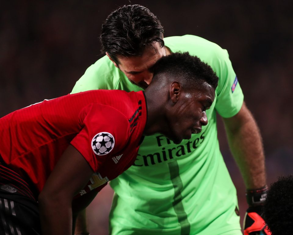 PSG goalkeeper Gianluigi Buffon whispers in to the ear of his old Juventus team-mate Paul Pogba