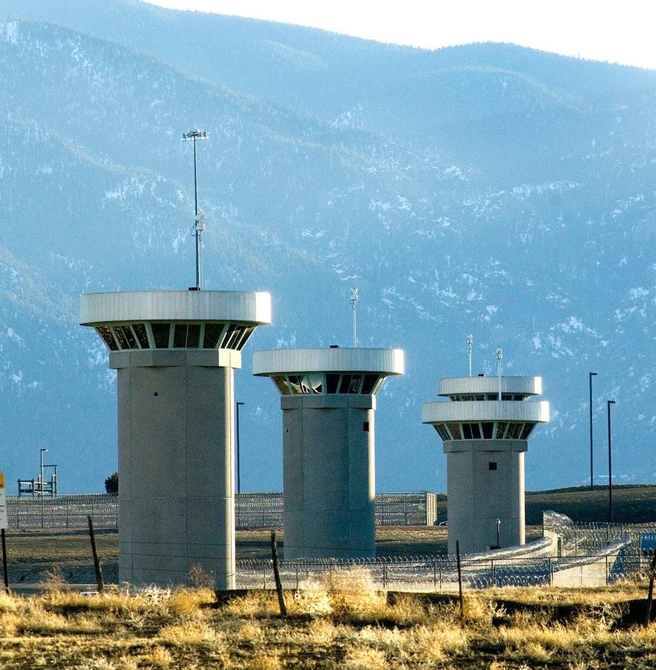  Guard towers, manned by armed guards, loom over the prison