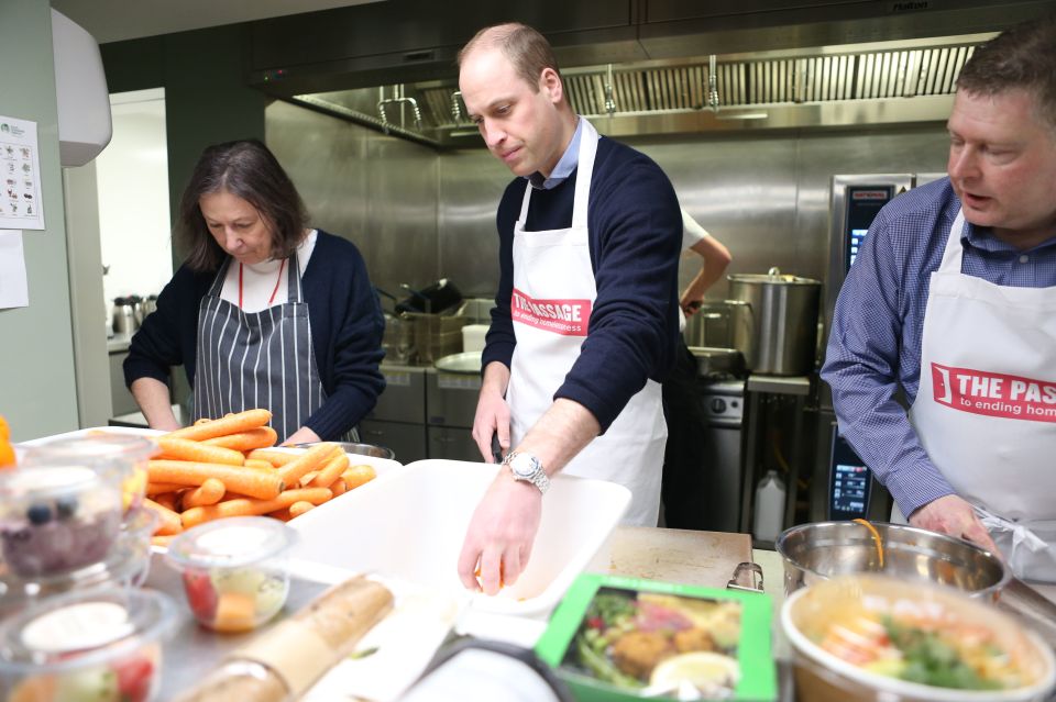  The Duke of Cambridge joins volunteers helping to prepare and serve lunch during a visit to homelessness charity The Passage in central London