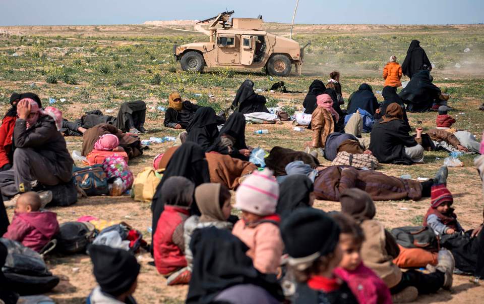  Civilians gather in a field near Baghouz as they flee ISIS