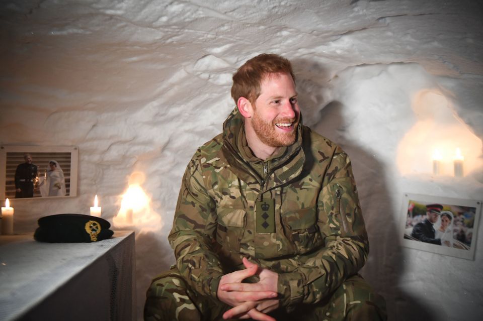  Harry was all smiles as he spotted a photograph on the wall of a makeshift shelter built of snow during a visit to British forces