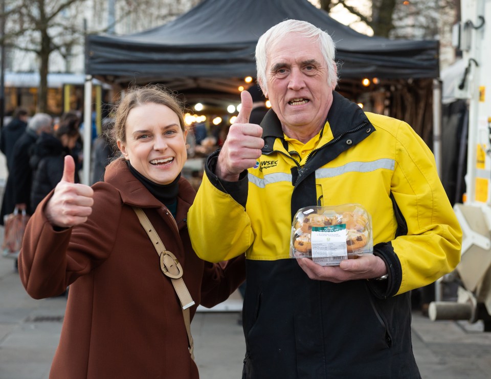 Sun girl Laura Stott gives some muffins to security guard Robert Mott