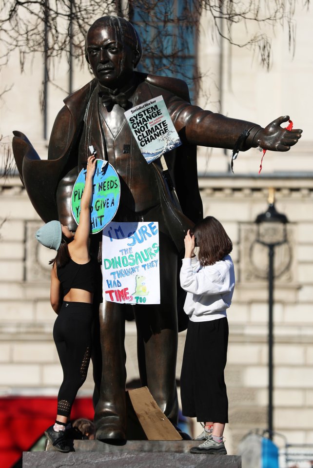  Signs were attached to the country's former PM's statue, Winston Churchill