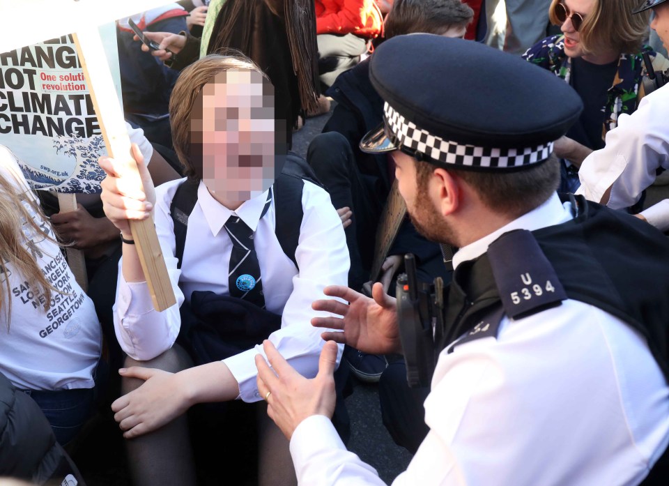  One girl shouts in the face of a police officer