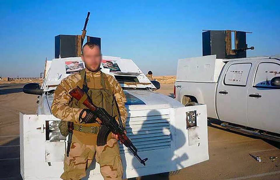  A Russian mercenary beside an armoured vehicle