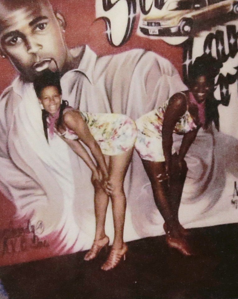  Latresa Scaff, left, and Rochelle Washington posing in front of a picture of R Kelly on the night they claim he assaulted them