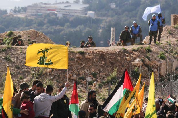 Lebanese supporters of the Shiite Hezbollah movement attending a rally in the Lebanese border with Israel