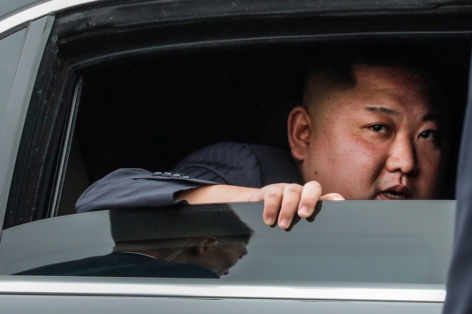 Kim peers out of the window of his armed Mercedes outside the North Korean Embassy in Hanoi