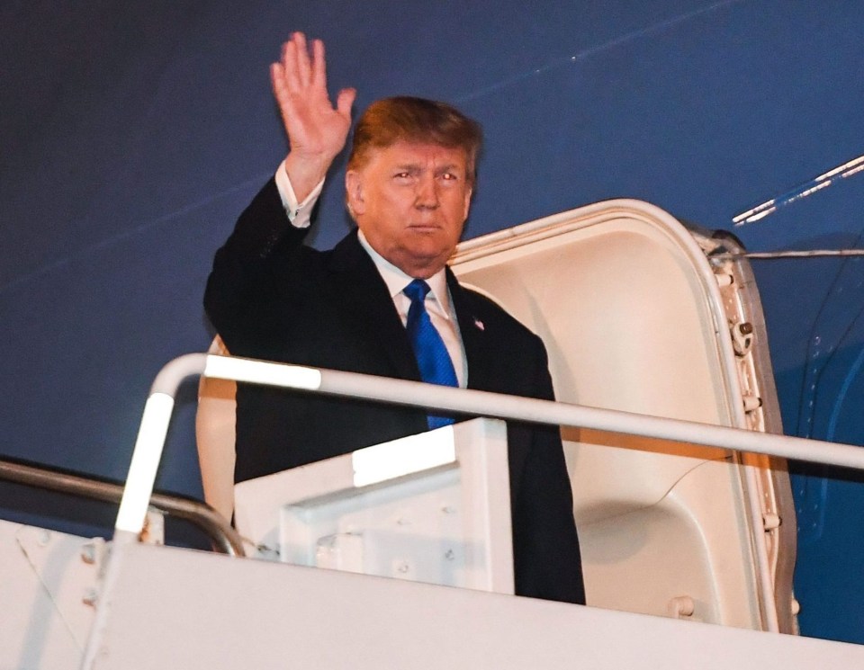 The US president looked grim-faced after touching down in Hanoi