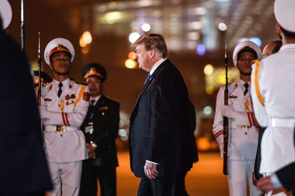 Vietnamese soldiers stand guard for the world leader as he steps off the aircraft