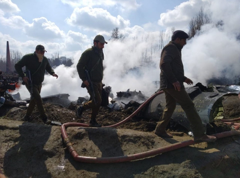 Indian security guards are seen at the crash site after an Indian Air Force plane crashed in Kashmir