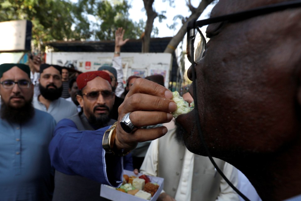 People in Karachi, Pakistan, handed out sweets to celebrate the shooting down of two Indian military planes