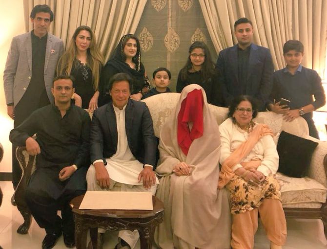  Imran Khan, centre, sits next to his third wife, Bushra Maneka, whose face he didn't see until after they were wed