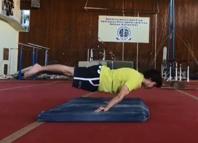 After performing a backflip, Alexander Didenko is able to suspend his body before his feet reach the ground