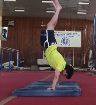 After performing the backflip he then turns it into a handstand