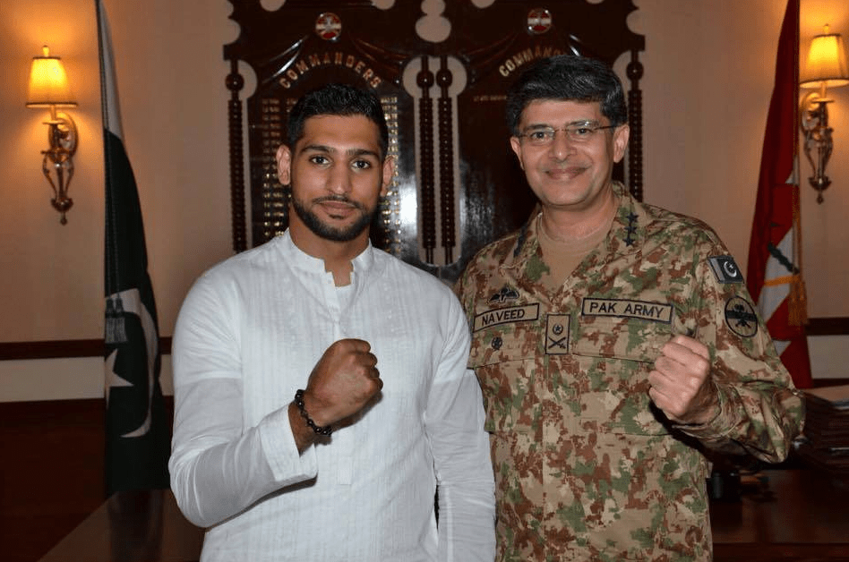 Khan poses with a man who appears to be former Lieutenant-General of the Pakistan army, Naveed Mukhtar