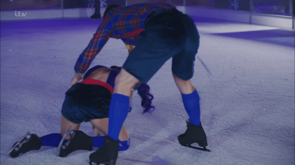  Hamish Damon attends to Saara Aalto after she flips and bangs her head on the ice