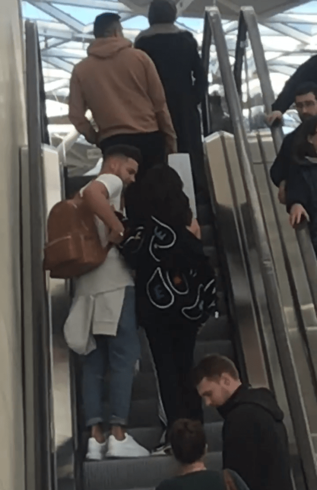 They were seen with their arms around each other on the escalator