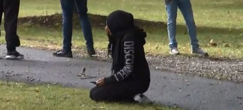 A worshipper sits outside the mosque after the massacre