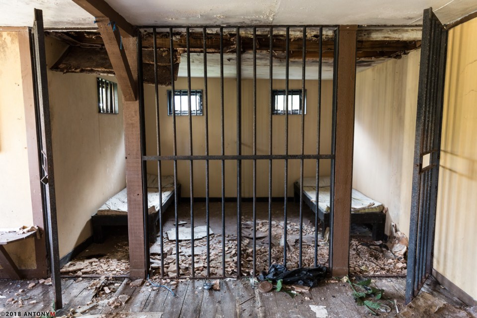  Leaves and debris litter in what was once an open jail cell in the park