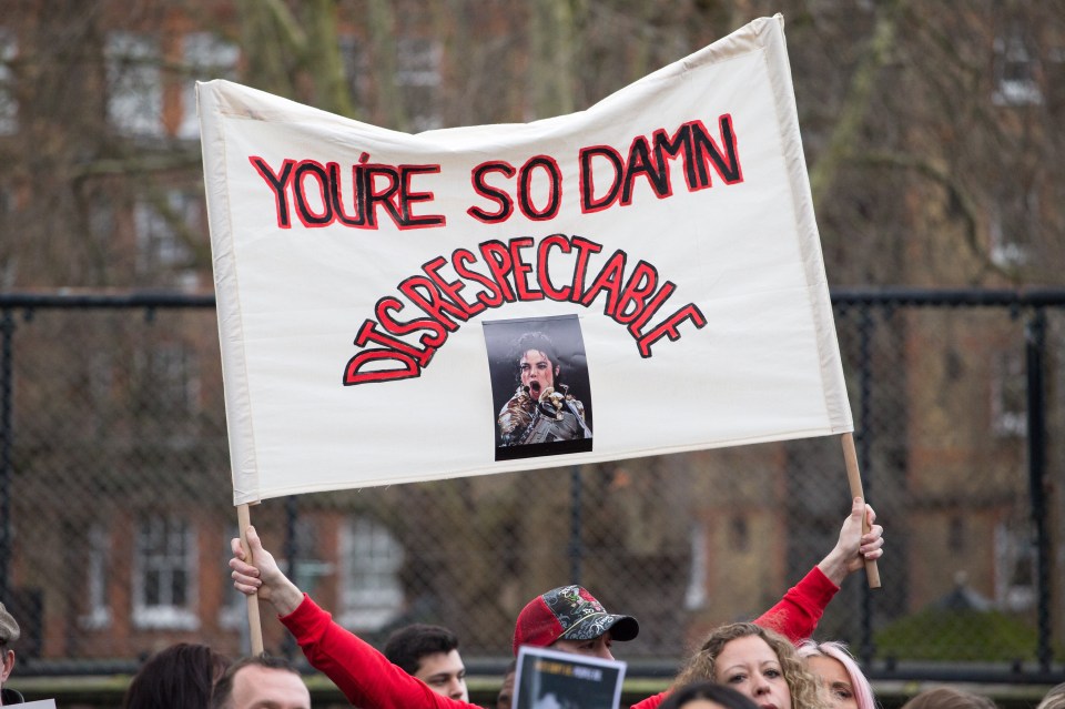  A banner voices one fan's anger about the allegations in the documentary