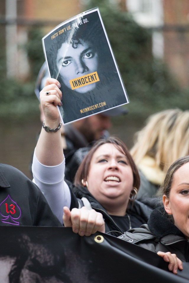  A woman at the protest holding up a picture of Jackson