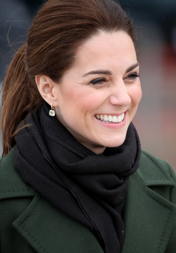 The Duchess of Cambridge grins as she speaks to locals