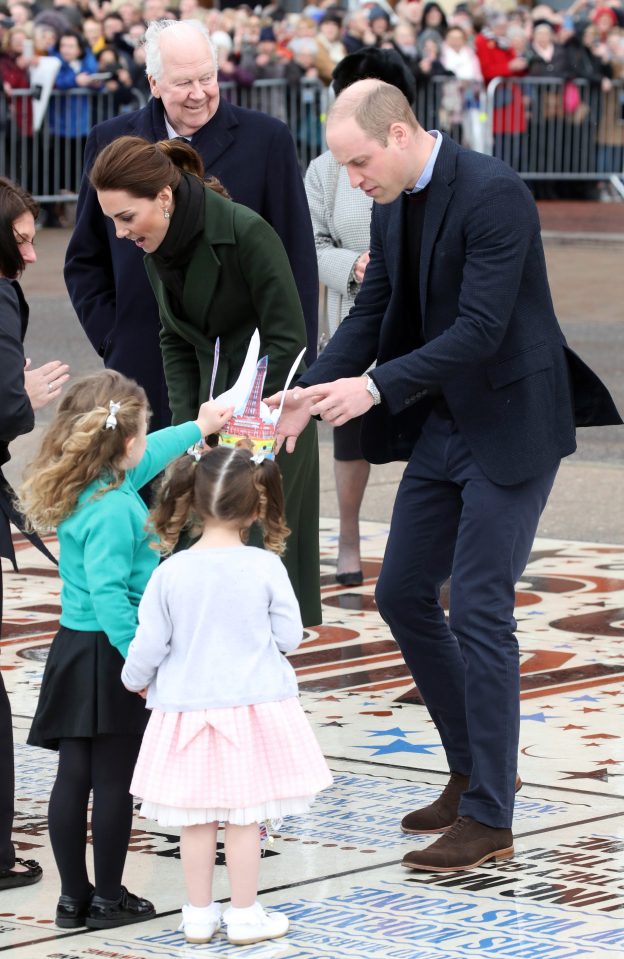 Prince William is given a crown by a local