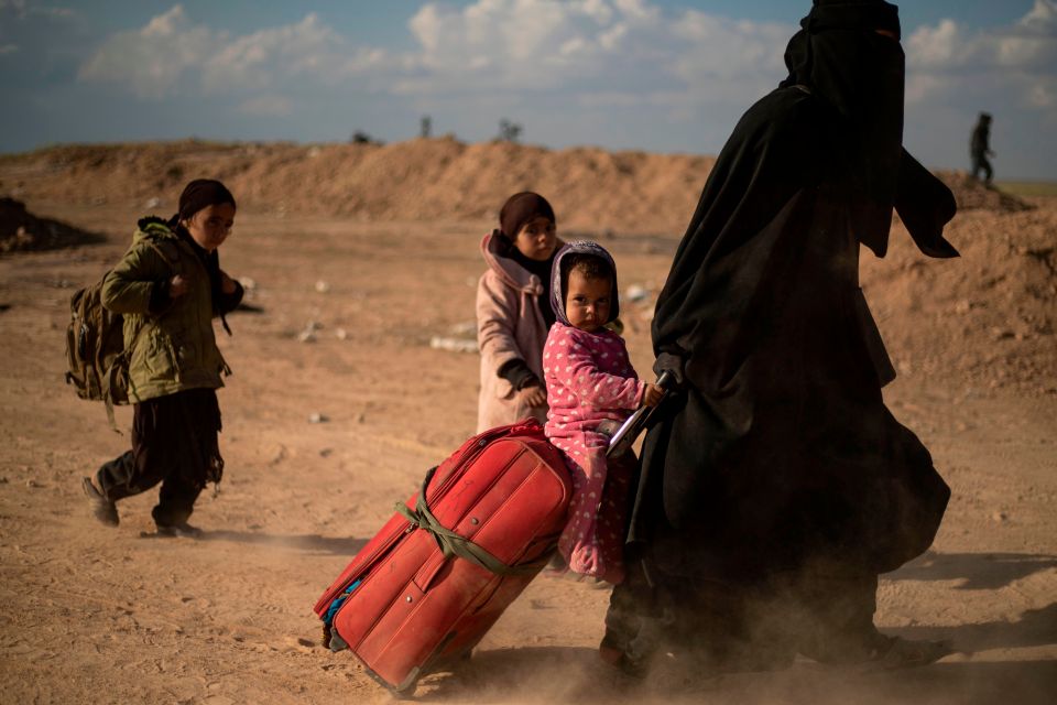  A woman evacuated with her children from the holdout of Baghouz. ISIS brides have vowed revenge