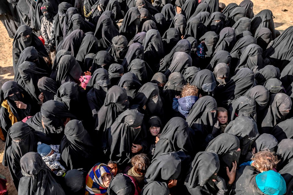 Civilians evacuated from the Islamic State (IS) group’s embattled holdout of Baghouz wait for bread and water at a screening area