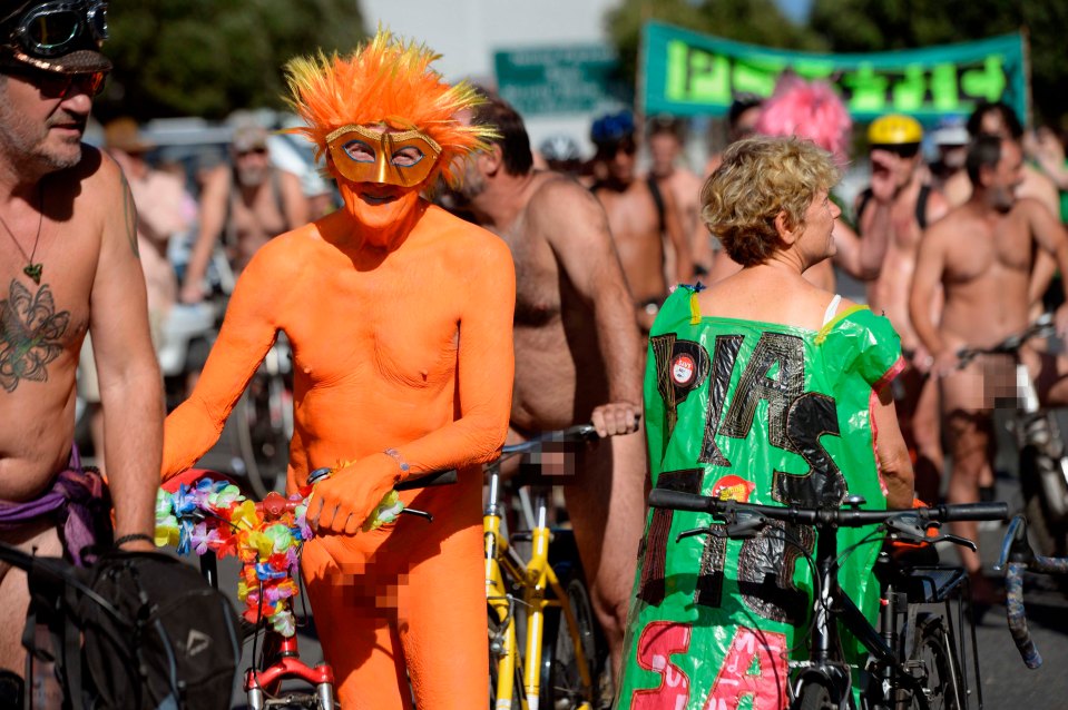 This man wore a feathered mask to participate in the Naked Bike Ride