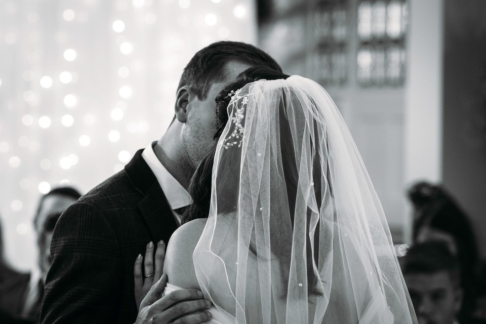 The strangers’ first kiss comes in front of their loved ones at the wedding