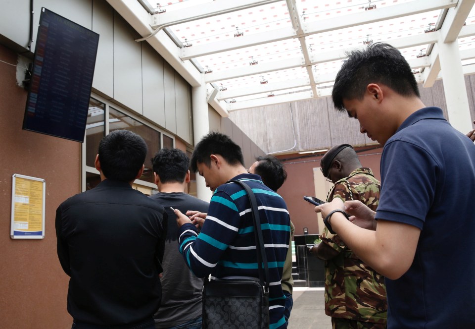 People wait for news on the crashed plane and other delayed flights in Nairobi