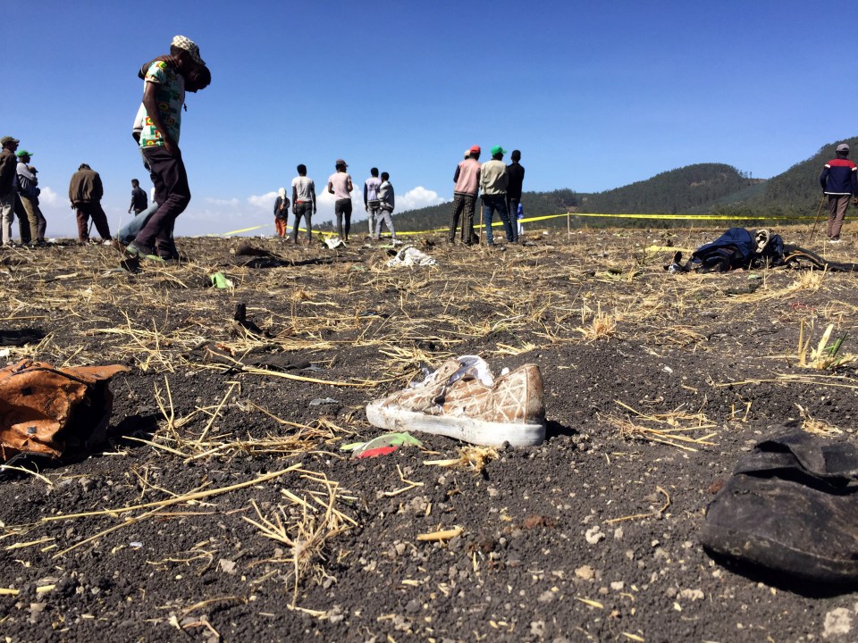 Tragic debris littering the ground includes a shoe and items of clothing from victims of the fatal crash