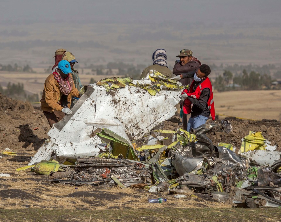 Workers collect wreckage from the Ethiopia Airlines jet that crashed yesterday