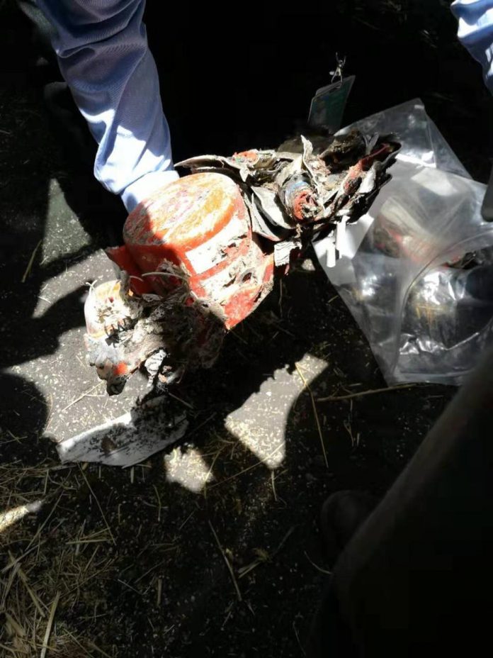 The black box flight recorder is recovered from the crash site