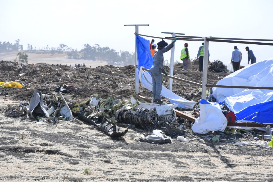 Rescue workers search the site for pieces of the wreckage of an Ethiopia Airlines Boeing 737 Max 8 aircraft near Bishoftu