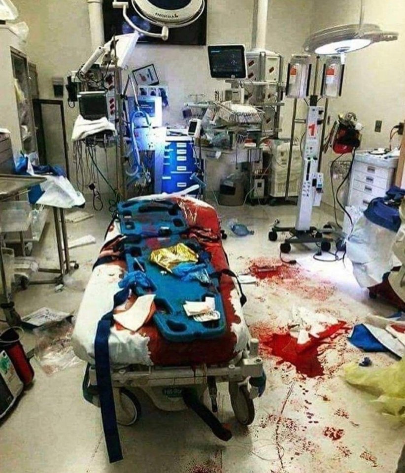  The horrifying image shows a shocking amount of blood covering the hospital room and bed