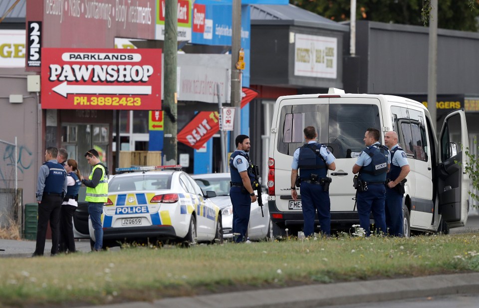 Police stand outside a mosque in Linwood, Christchurch this morning