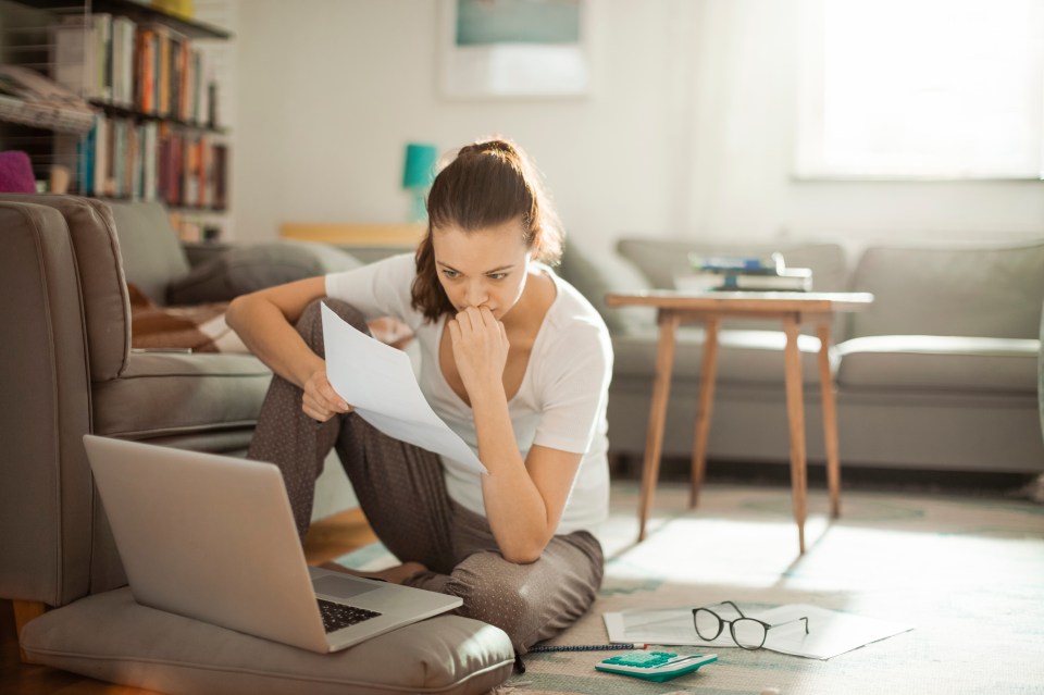 Lady on laptop worried about debts