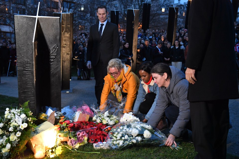 People take part in a vigil at the New Zealand War Memorial on Hyde Park Corner following the mosque attacks in Christchurch