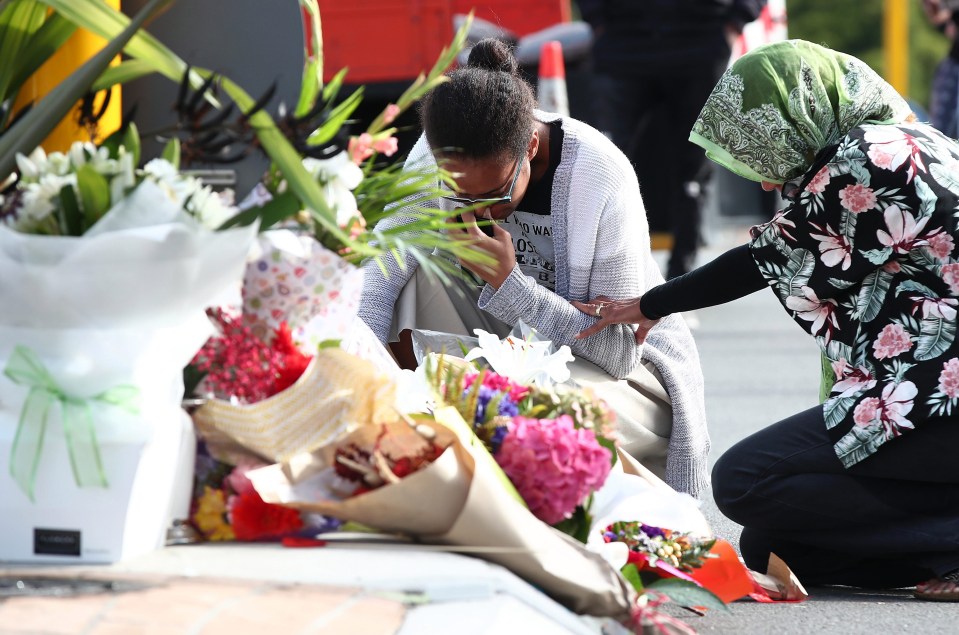 There were emotional scenes as people laid floral tributes outside the mosque on Deans Avenue in Christchurch