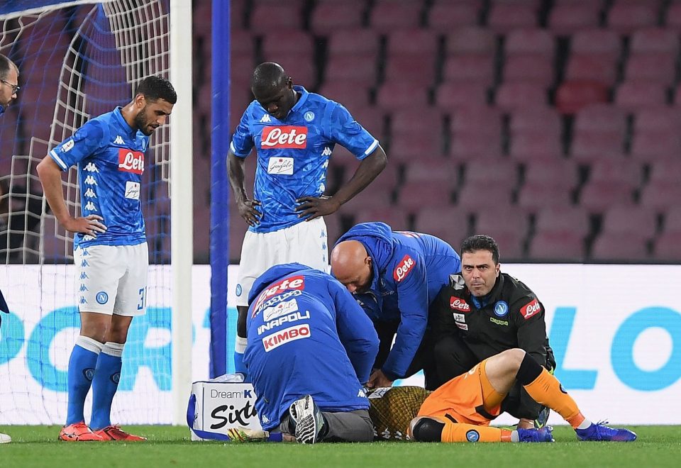 Napoli medics treat David Ospina after he falls to the floor during the match