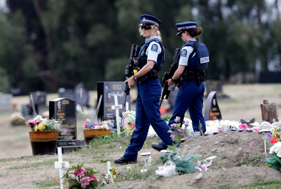 Armed police officers patrol the area, following the massacre