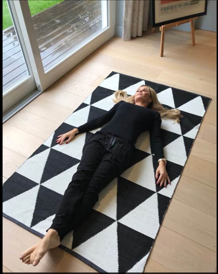 Amanda lies on rug from her QVC collection